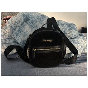 Black Steve Madden Sherpa mini backpack with tassel